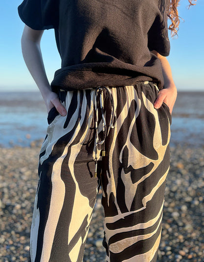 woman wearing zebra print wide leg trousers