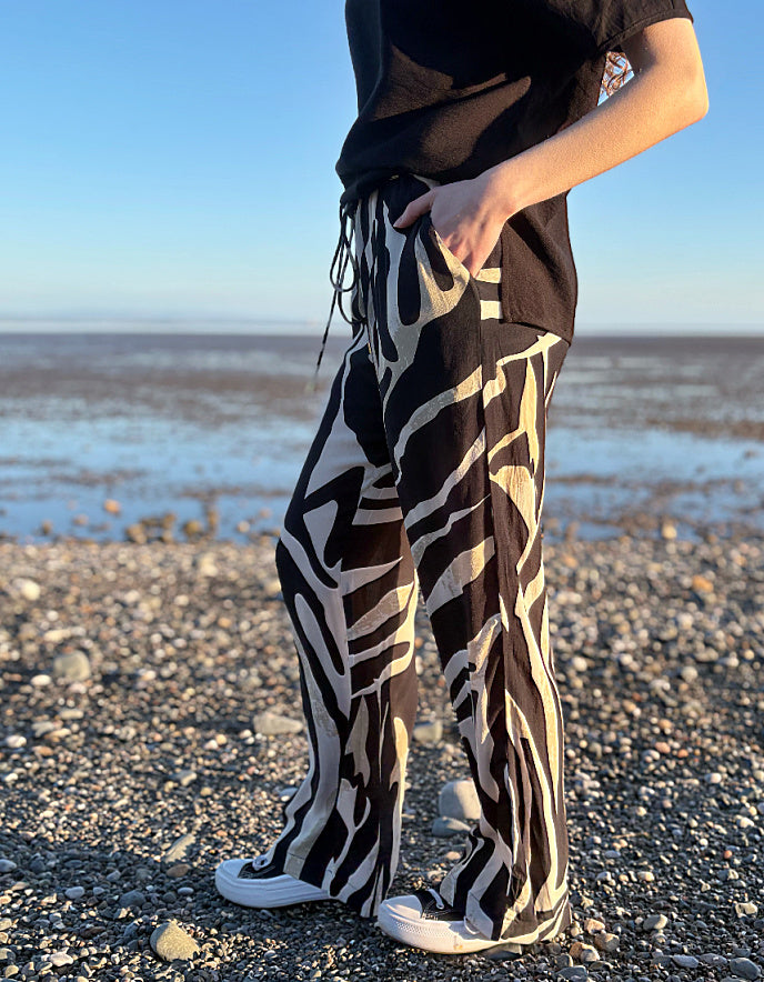 woman wearing zebra print wide leg trousers