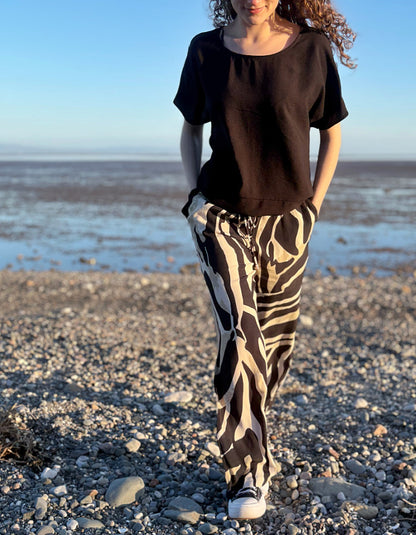 woman wearing zebra print wide leg trousers