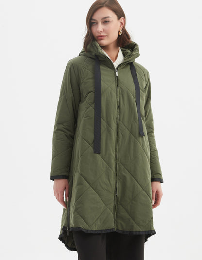 Woman wearing a green quilted coat on a white background