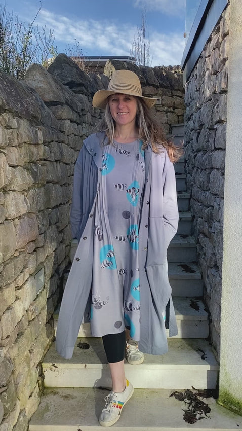 bamboo silk dress with loose shaped fit and pin tuck darting down each side at the front, grey background with turquoise blue bubble print with white and grey striped fish, lovely soft silky feel