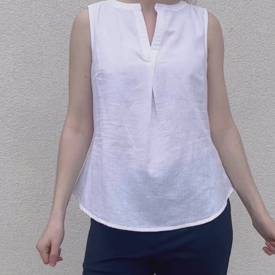 white cotton linen sleeveless sun top with cut out neckline and front pleat for slight swing
