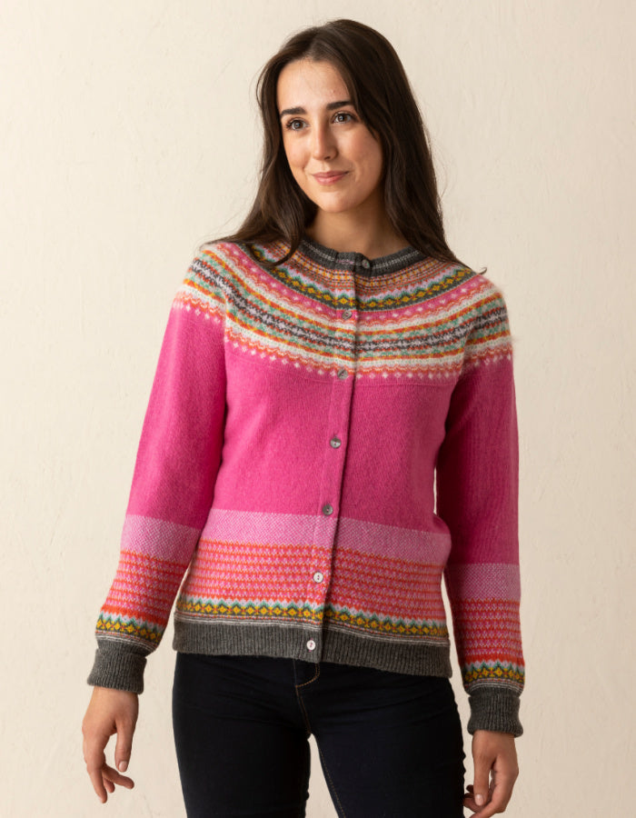 eribe alpine cardigan in fiesta features pink in the main body with green orange yellow and white Fair Isle design in the yoke and hem and cuffs