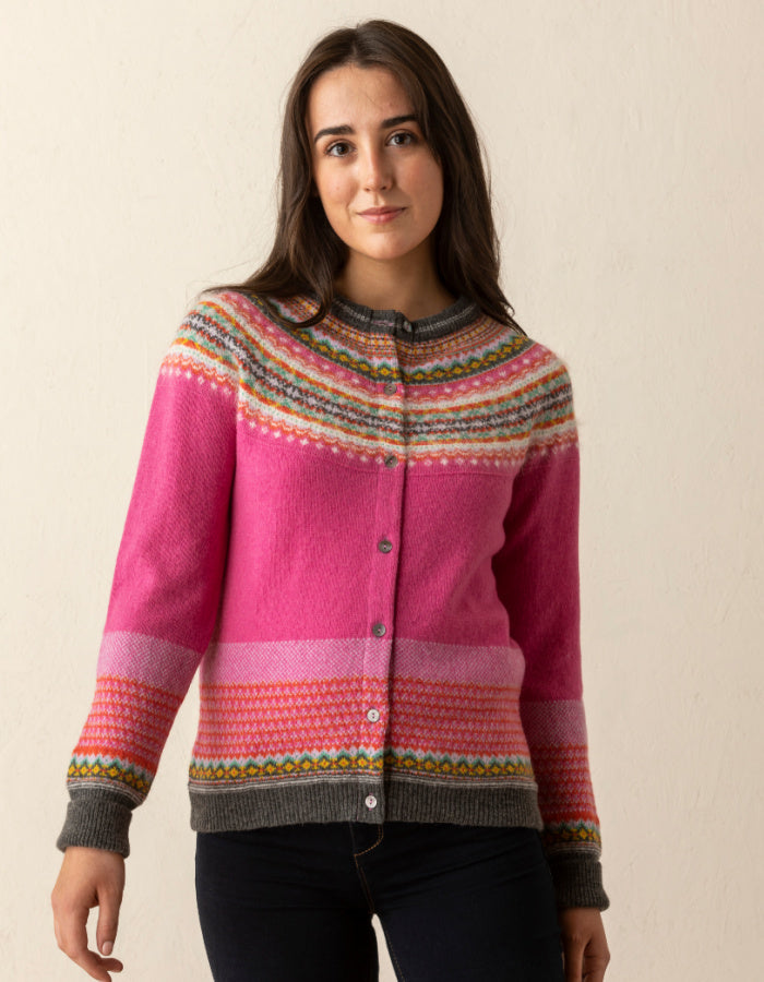 eribe alpine cardigan in fiesta features pink in the main body with green orange yellow and white Fair Isle design in the yoke and hem and cuffs