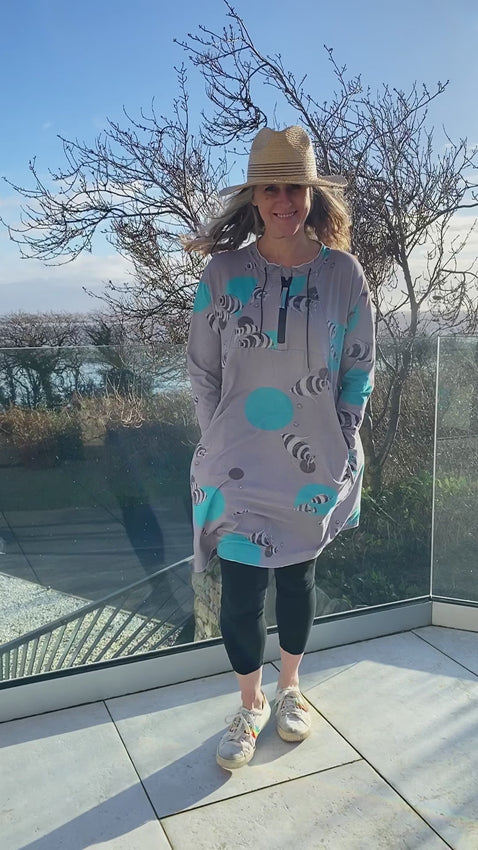 grey cotton stretch jersey tunic with turquoise fish print and half zip, two pockets with zip closure