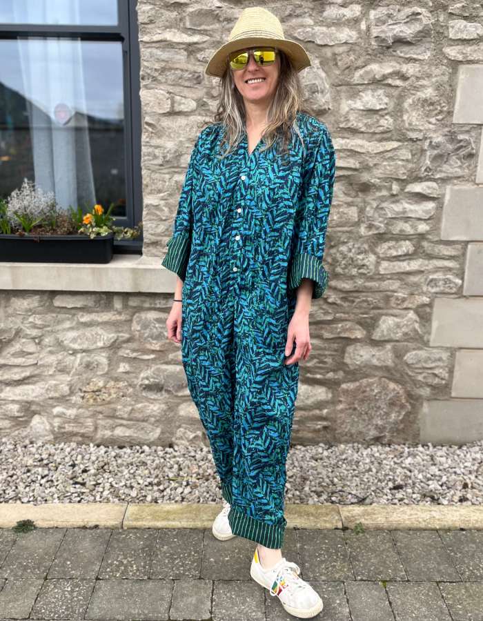 all in one cotton jumpsuit with button up front, 3/4 length sleeves in blue and green fern print with striped turn ups on cuffs and hems
