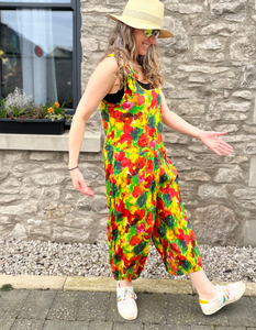 cotton sleeveless jumpsuit 3/4 length leg with loose balloon shape and elasticated cuffs, tie shoulder straps in red green and red poppy print
