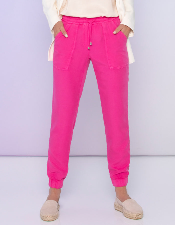 hot pink jogger style troousers with elasticated waist with adjustable toggle ties and elasticated cuffs, pockets front and rear