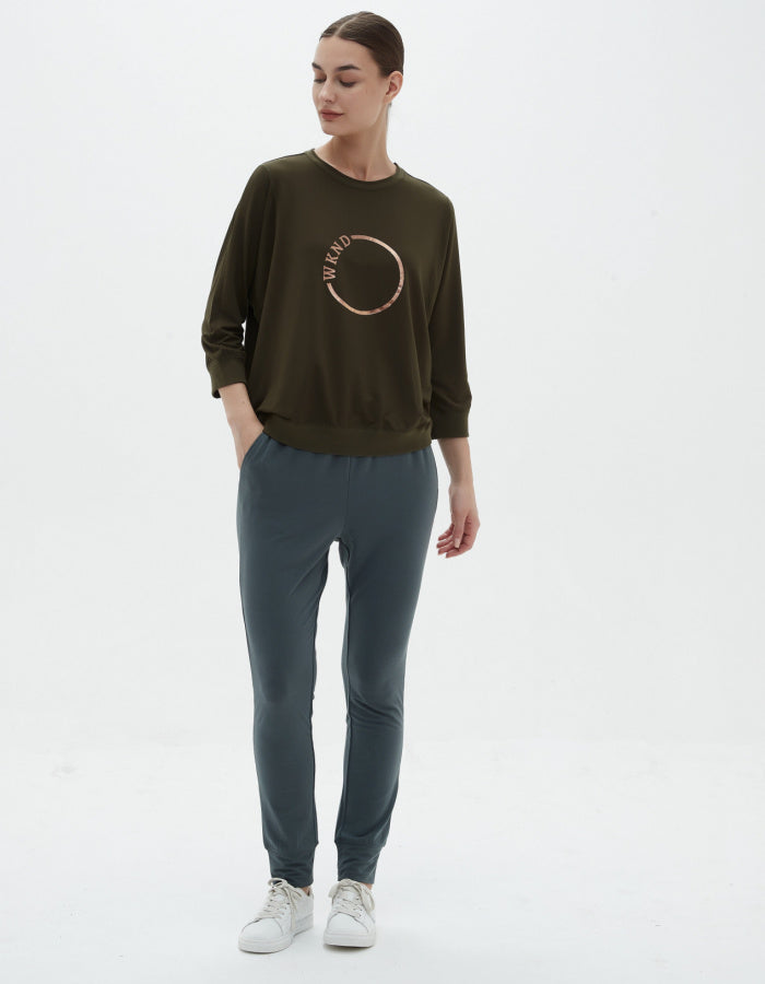 loose fit khaki bamboo sweatshirt top with scoop neckline and 3/4 sleeve, rose gold logo in a circle with the letters WKND